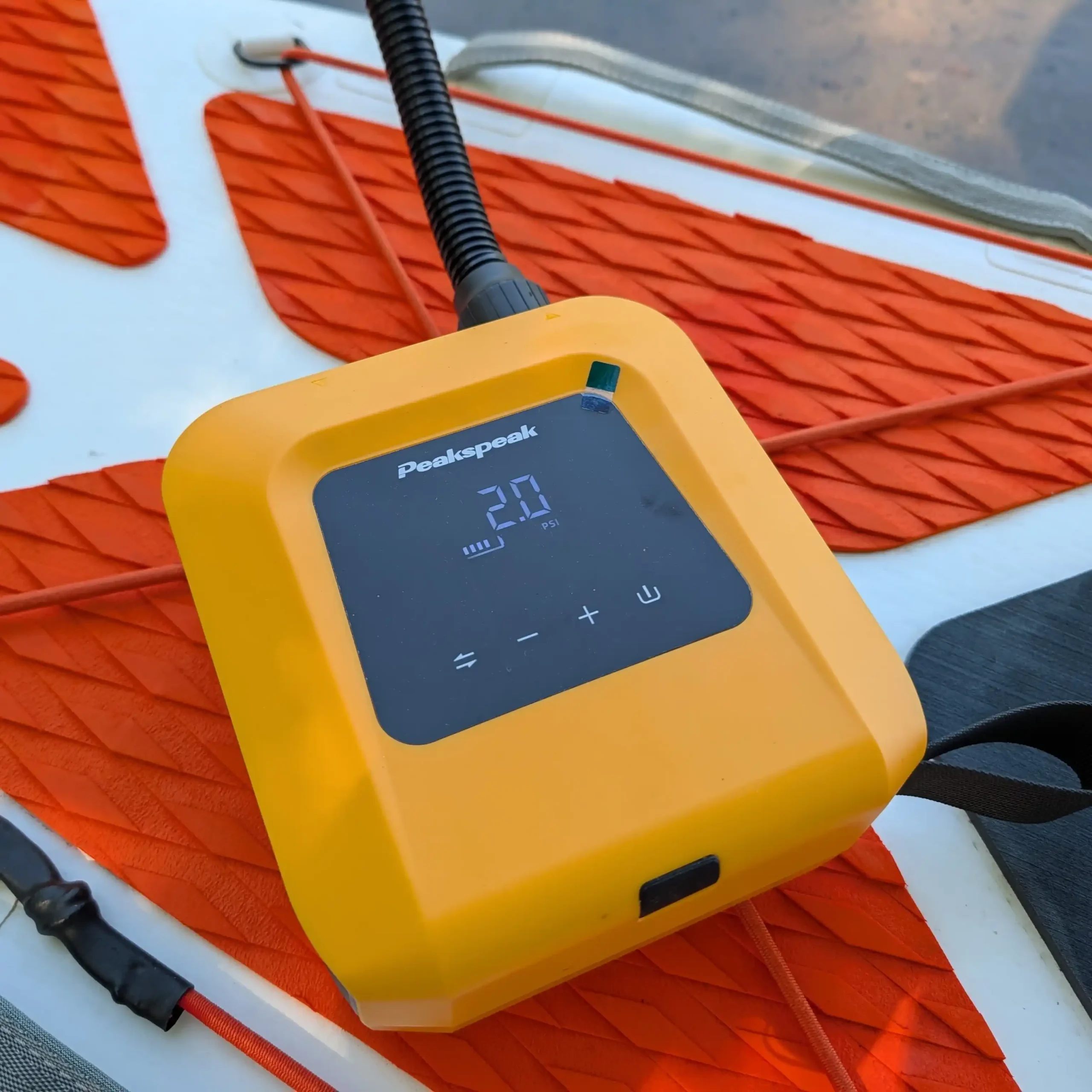 Close-up of Peakspeak electric SUP pump controls and hose